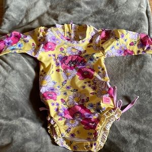 Adorable Ruffle Butts rash guard. Worn only for pictures